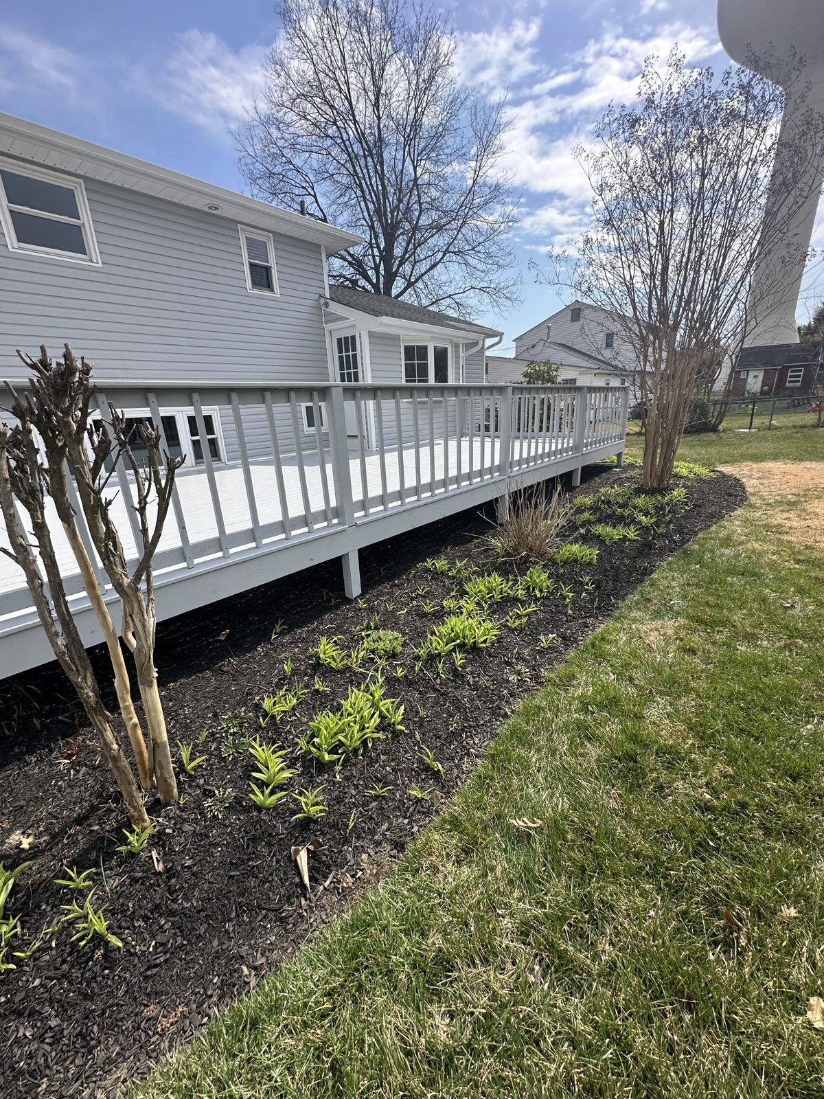 Home exterior with white painted deck railing
